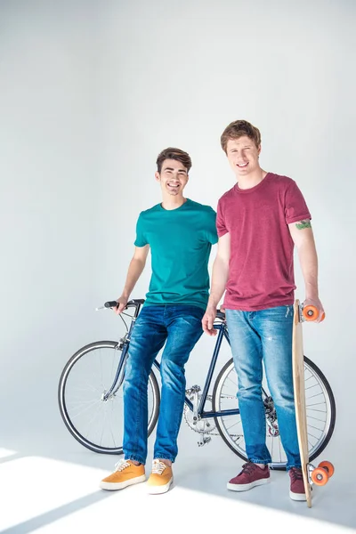 Friends with bicycle and skateboard — Stock Photo