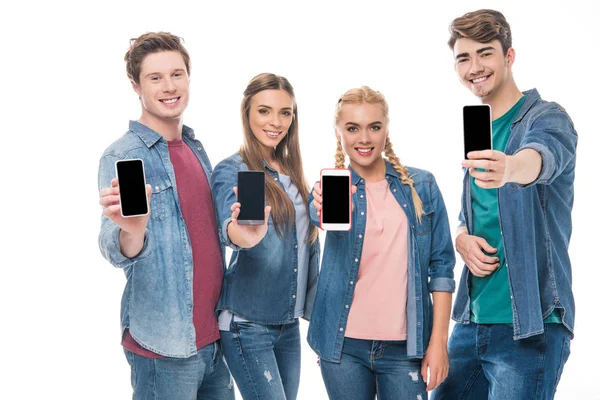 Young friends holding smartphones — Stock Photo