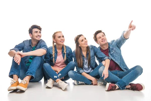 Jóvenes amigos apuntando lejos - foto de stock