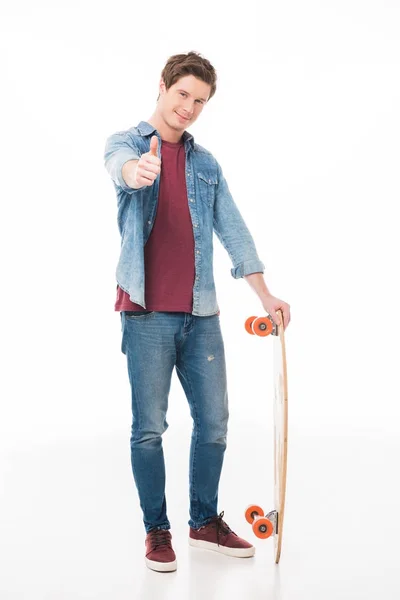 Man with skateboard showing thumb up — Stock Photo