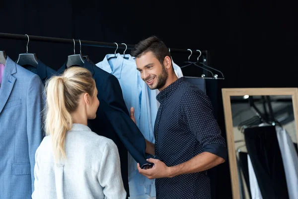 Couple choosing suit in boutique — Stock Photo