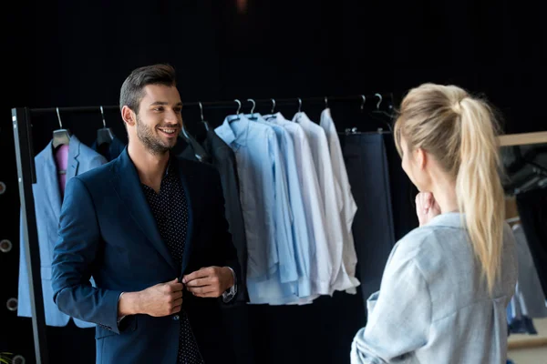 Couple choosing suit in boutique — Stock Photo