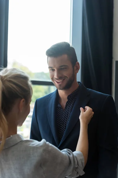 Couple choosing suit in boutique — Stock Photo