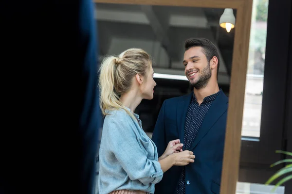 Couple choosing suit in boutique — Stock Photo