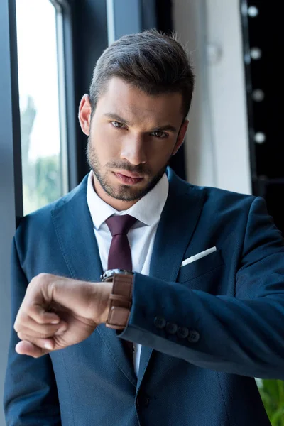 Businessman checking wristwatch — Stock Photo