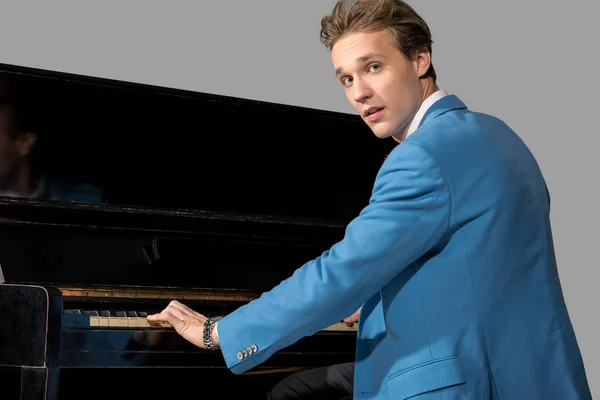 Young man playing on piano — Stock Photo