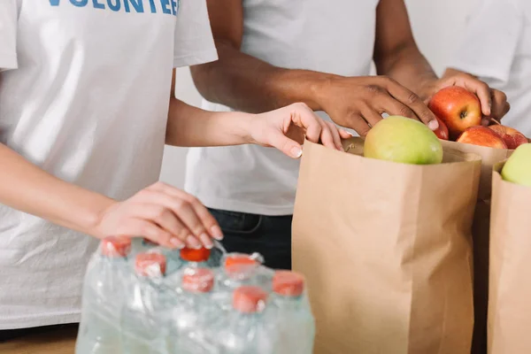 Volunteers with charity goods — Stock Photo