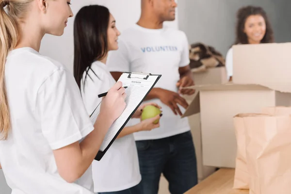 Female volunteer with clipboard — Stock Photo