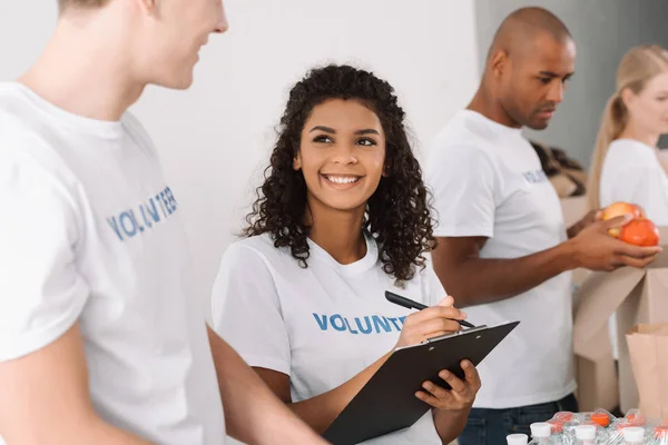 Volunteers working together — Stock Photo