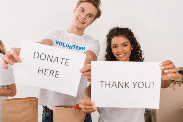 Volunteers holding charity placards — Stock Photo