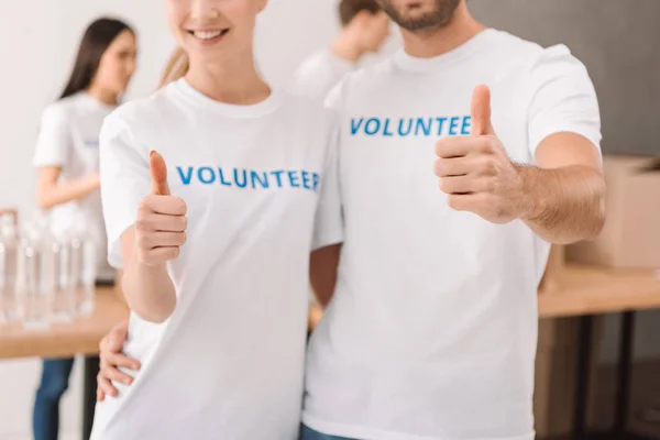 Volunteers showing thumb up — Stock Photo