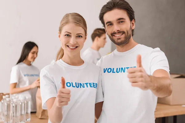 Volunteers showing thumb up — Stock Photo