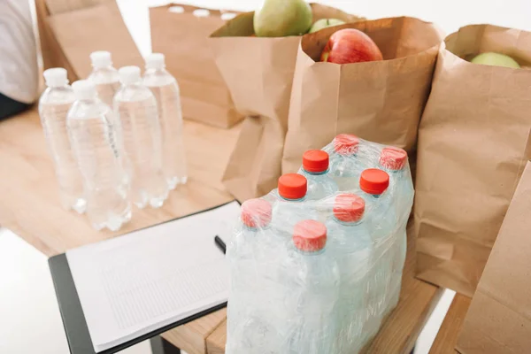 Clipboard and charity goods — Stock Photo