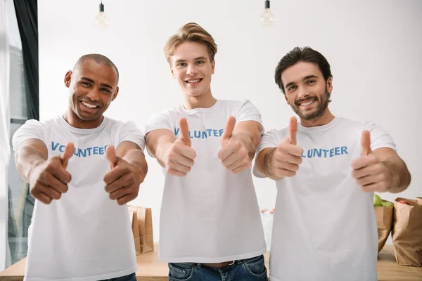 Volunteers showing thumbs up — Stock Photo