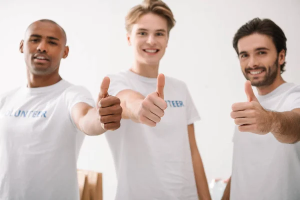 Volunteers showing thumbs up — Stock Photo