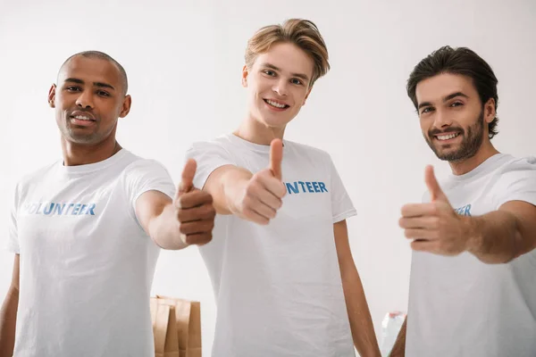 Volunteers showing thumbs up — Stock Photo