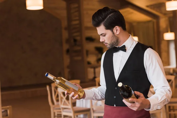 Waiter choosing wine — Stock Photo