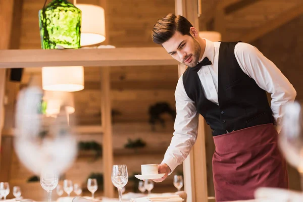 Waiter serving cup of coffee — Stock Photo