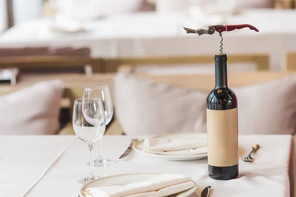 Bottle with corkscrew — Stock Photo