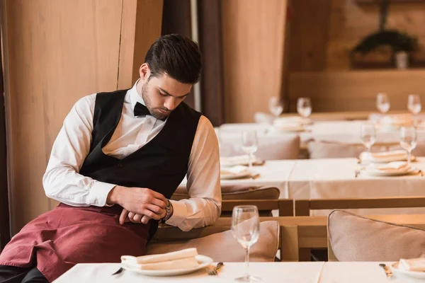 Waiter looking at watch — Stock Photo