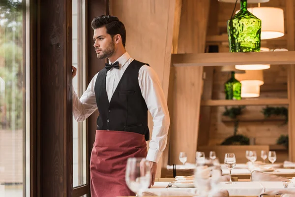 Waiter looking at window — Stock Photo