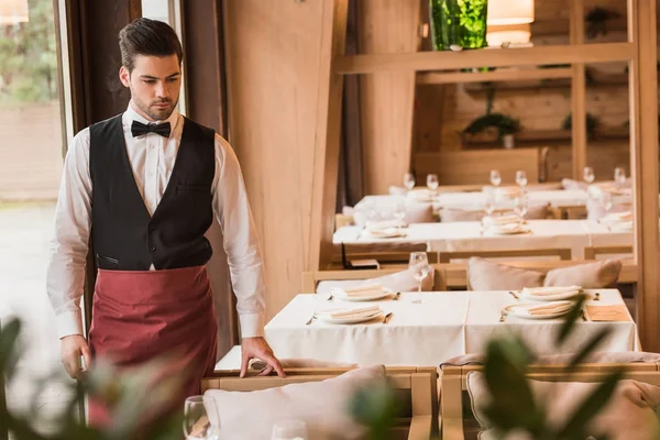 Waiter looking at served table — Stock Photo