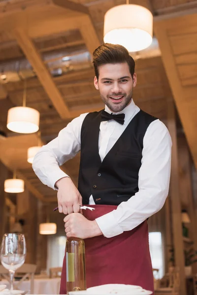 Waiter opening bottle of wine — Stock Photo