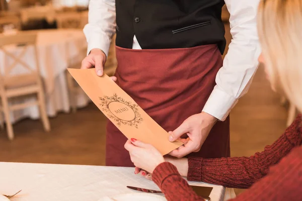 Waiter giving menu — Stock Photo