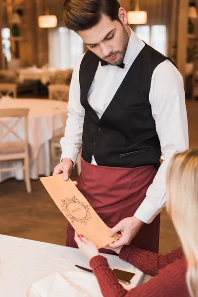 Waiter giving menu — Stock Photo