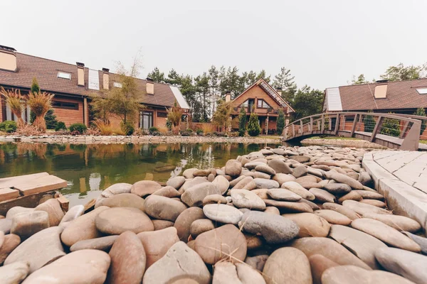 Stones at pond shore — Stock Photo