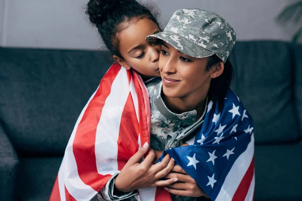 Filha beijando mãe em uniforme militar — Fotografia de Stock