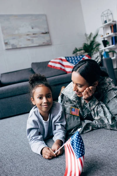 Daughter and mother with american flag — Stock Photo
