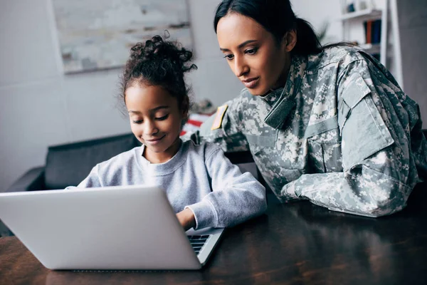 Mother and daughter using laptop — Stock Photo