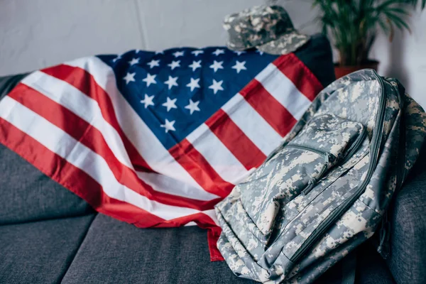 American flag and camouflage backpack — Stock Photo