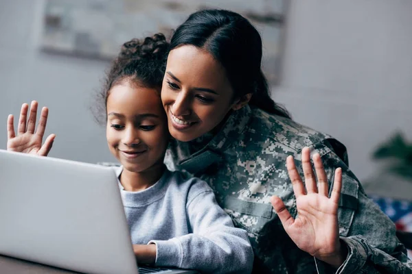 Soldier and daughter making video call — Stock Photo