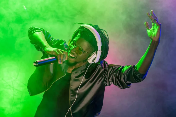 DJ singing with microphone on concert — Stock Photo