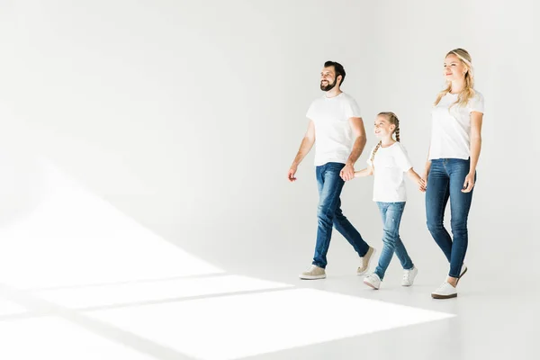 Family holding hands and walking — Stock Photo