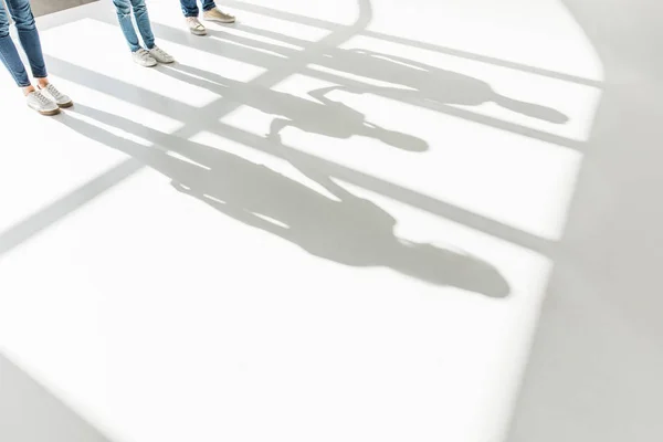 Legs of family and shadows — Stock Photo