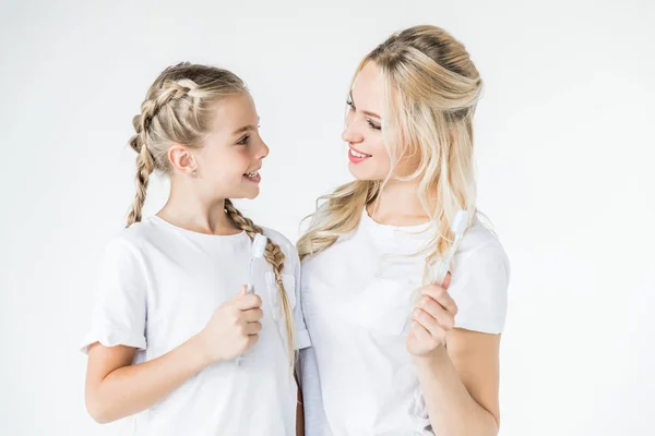 Mother and daughter with toothbrushes — Stock Photo