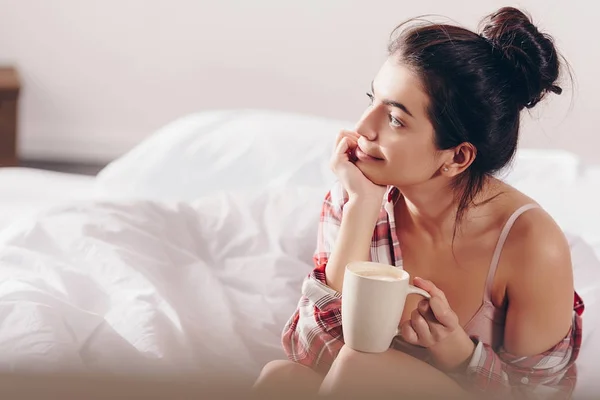 Dreamy girl with coffee in bed — Stock Photo
