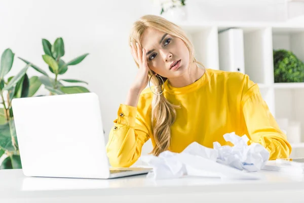 Geschäftsfrau mit zerknülltem Papier und Laptop — Stockfoto