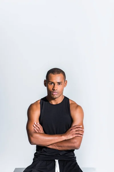 Confident young african american sportsman with crossed arms looking at camera isolated on grey — Stock Photo