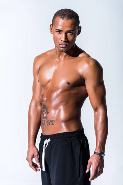 Athletic sweaty shirtless african american sportsman looking at camera isolated on grey — Stock Photo