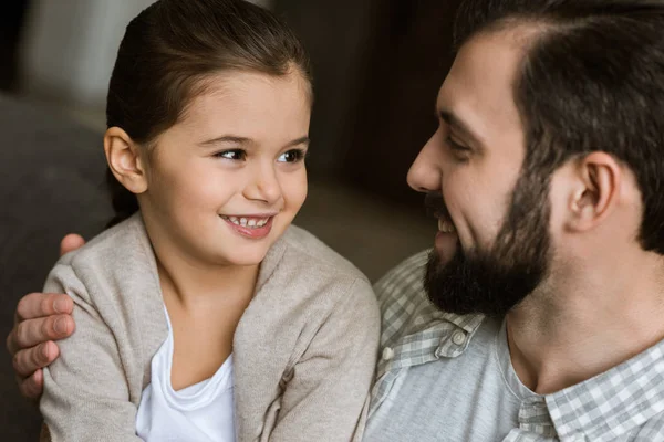 Pai feliz com a filha sorrindo e olhando um para o outro — Fotografia de Stock