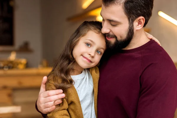 Father and adorable daughter hugging in cafe — Stock Photo
