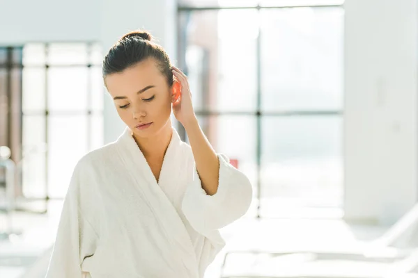 Sensual young woman in bathrobe relaxing at spa — Stock Photo