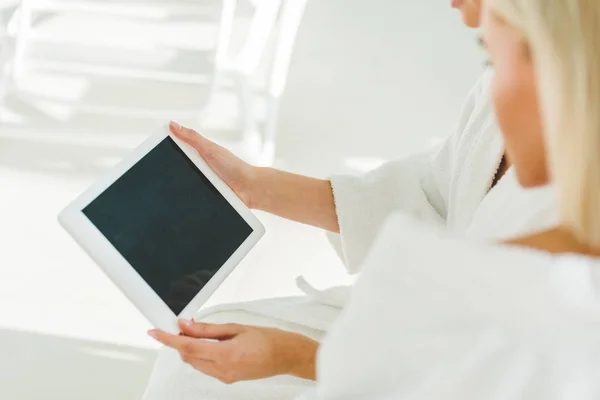 Cropped shot of young women using digital tablet at spa center — Stock Photo