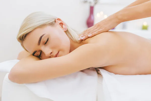 Close-up shot of beautiful young woman getting massage — Stock Photo