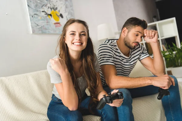 Woman celebrating victory in computer game over boyfriend — Stock Photo