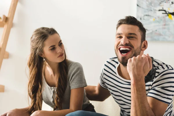 Man celebrating victory in computer game over girlfriend — Stock Photo